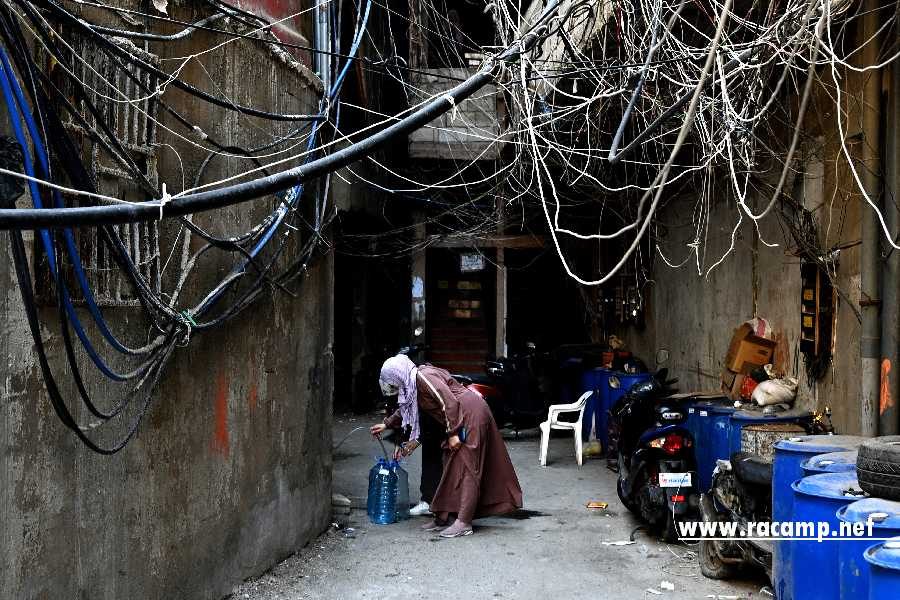 A woman fills containers with drinking water from a supply point in an alley of Beirut's Burj al-Barajneh camp for Palestinian refugees on May 14, 2024. Palestinians everywhere commemorate the Nakba, or catastrophe, on May 15 which they associate with Israel's creation and marks the exodus or forced displacement of hundreds of thousands of people from their homes in 1948. (Photo by JOSEPH EID / AFP) (Photo by JOSEPH EID/AFP via Getty Images)