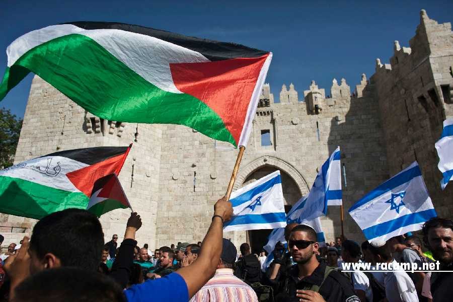 Palestinian protesters wave Palestinian flags as Israelis carrying Israeli flags walk past in front of the Damascus Gate outside Jerusalem's Old City during a parade marking Jerusalem Day May 8, 2013. Jerusalem Day marks the anniversary of Israel's capture of the Eastern part of the city during the 1967 Middle East War. In 1980, Israel's parliament passed a law declaring united Jerusalem as the national capital, a move never recognised internationally. There were confrontations on Wednesday between Muslims and Jews outside Jerusalem's walled Old City, where al-Aqsa mosque is located. Police arrested 10 Palestinians, police spokesman Micky Rosenfeld said. REUTERS/Nir Elias (JERUSALEM - Tags: POLITICS CIVIL UNREST ANNIVERSARY) - RTXZF09
